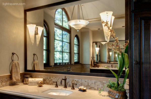 Two contemporary wall sconces and a central chandelier 
