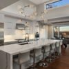 Beautiful kitchen in new luxury home, with waterfall island, sta
