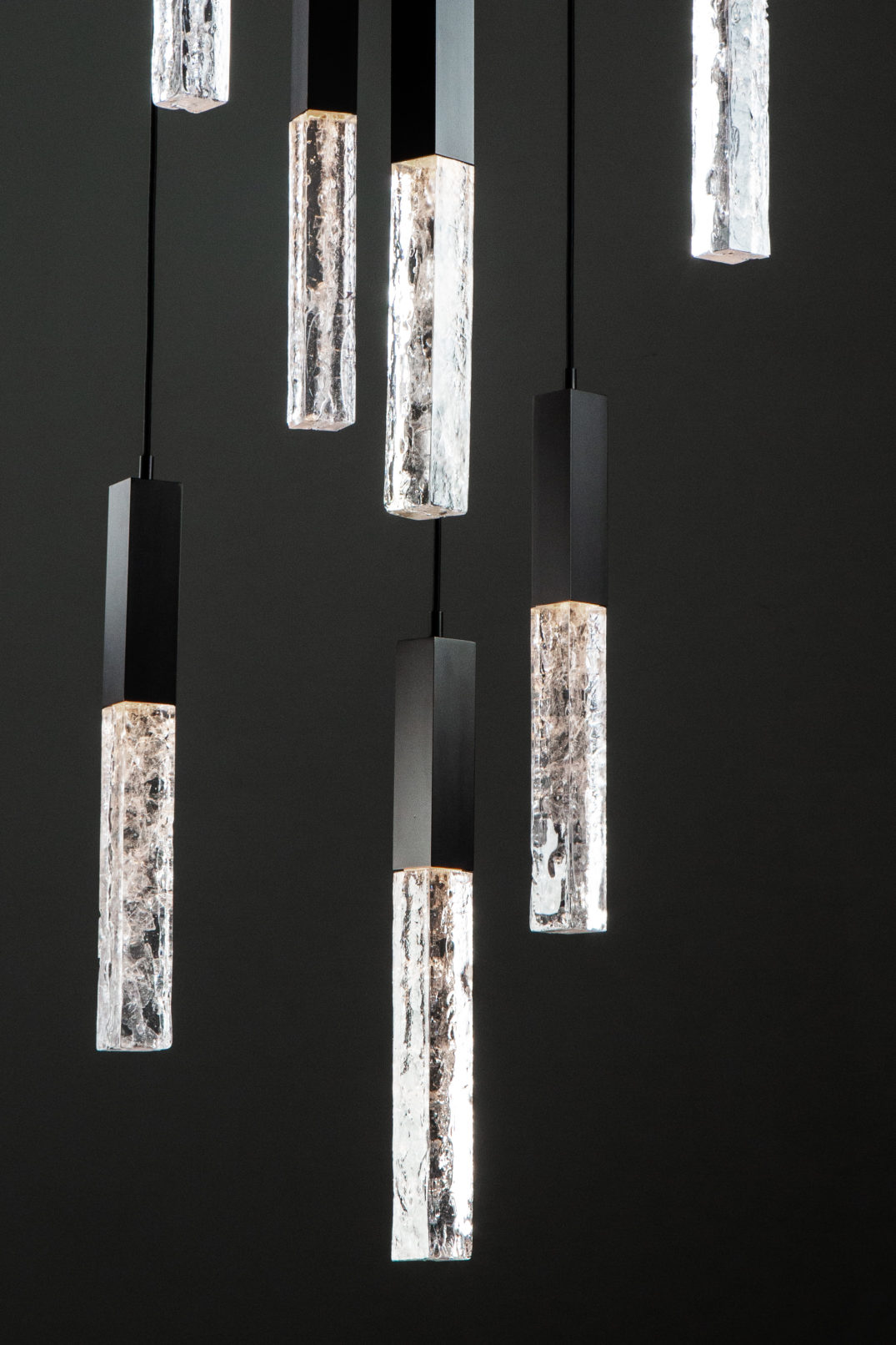 Detail of a Hammerton Studio Axis multi-light pendant light fixture highlighting the beauty of cast glass