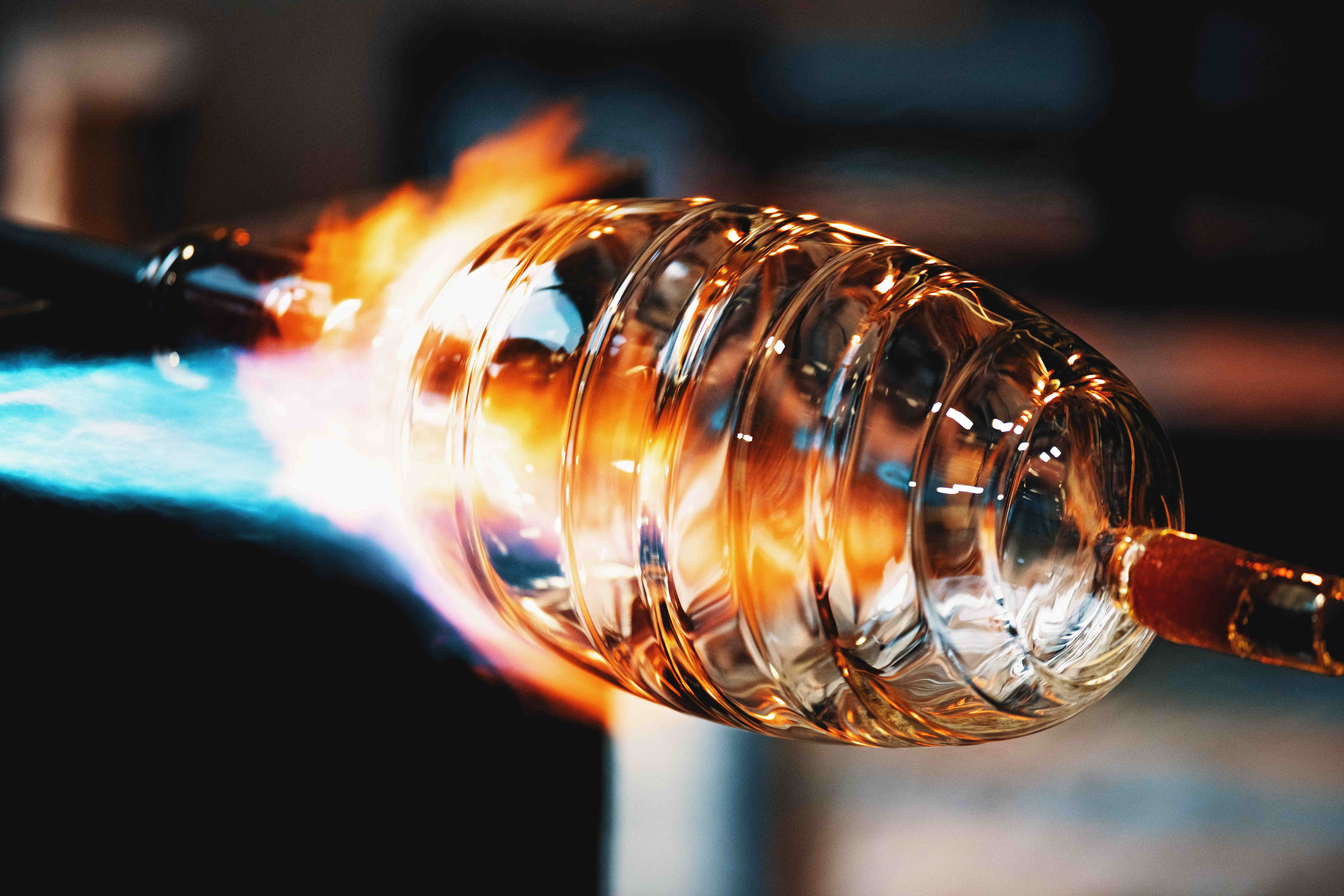 flames super-heat a crystal glass shade during the glass blowing process