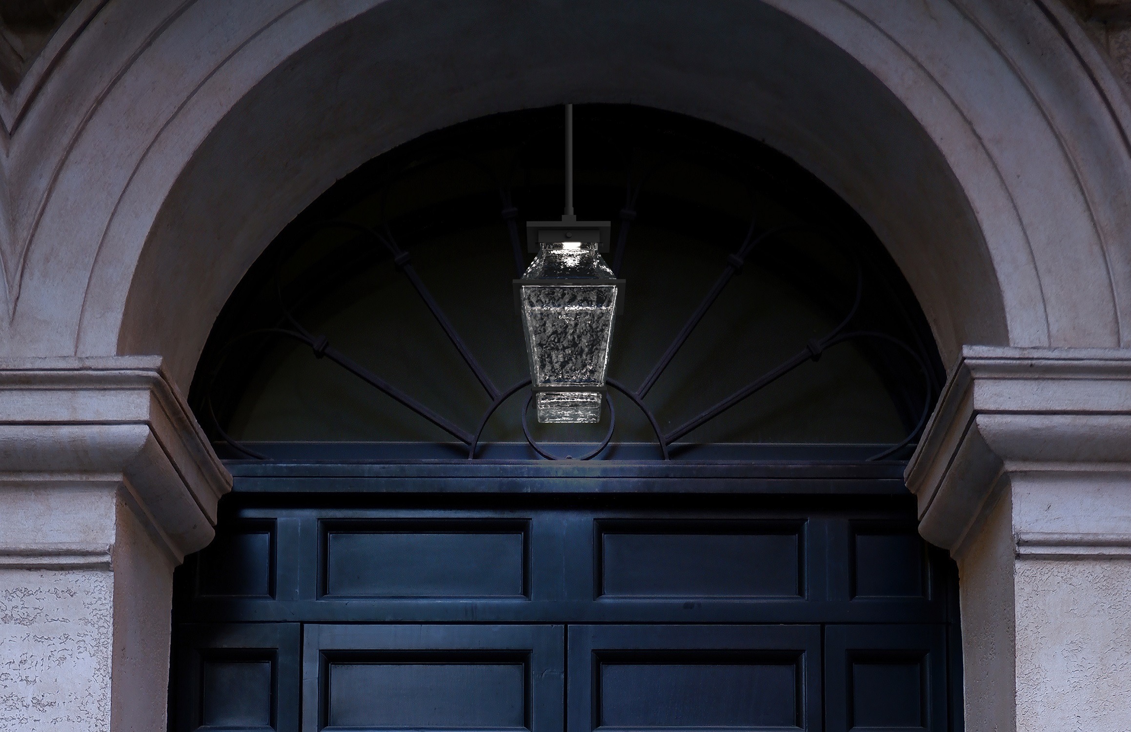A Hammerton Studio Landmark outdoor pendant light perfectly complements a stone arch entryway
