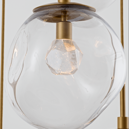 detail of a Hammerton Studio hand-blown glass light fixture containing a cast glass bulb lit by LEDs