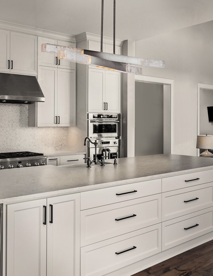 Axis pivot chandelier over a modern farmhouse kitchen island. 