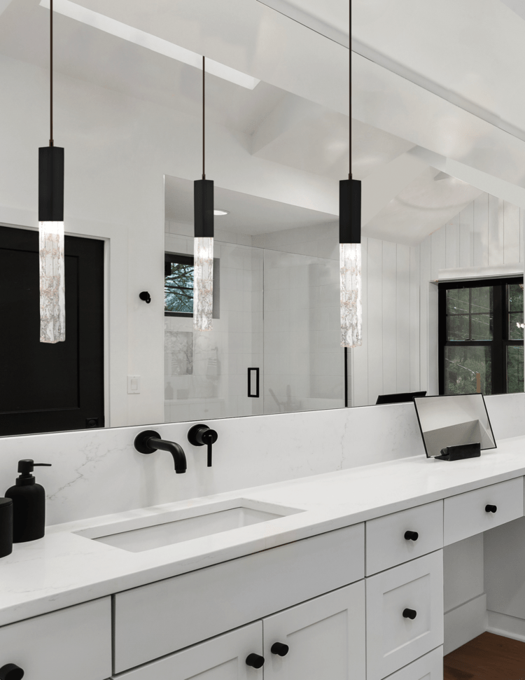 Axis pendants in a black and white modern farmhouse master bathroom. 