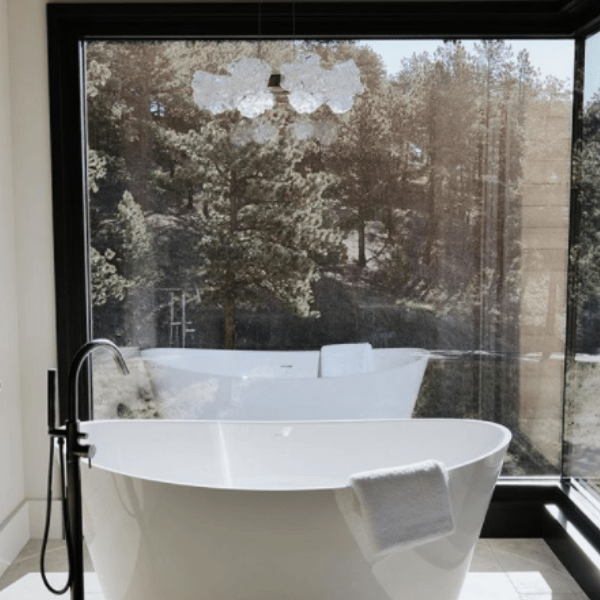 A Blossom ring chandelier brings the outdoors into this inviting bath space. Interiors: AMB Design | Holladay, UT