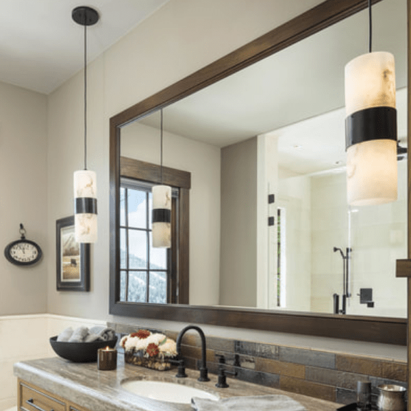 Custom onyx pendants accentuate a mountain bathroom. Interiors: Roxbury Studios l Salt Lake City UT