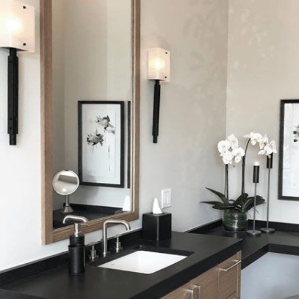 The hammered metal and artisan kiln fused glass featured in these Urban Loft Trestle sconces beautifully complement this contemporary powder room. Interiors: Mark and Aly Interior Design | Park City, UT