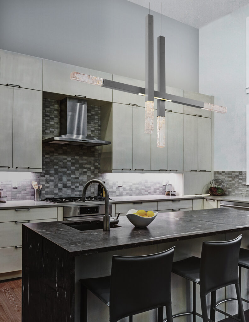 The long thin rectangular beams of metal and glass form straight, clean lines of this Axis chandelier by Hammerton Studio that perfectly complement the modern style of this modern kitchen