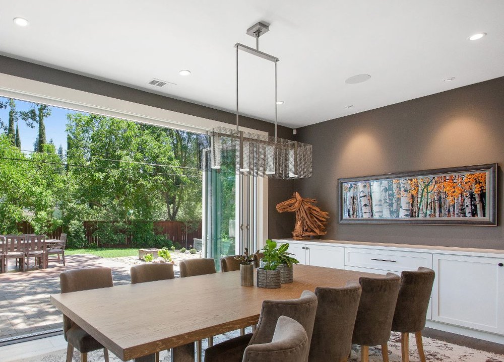 Another LMK project with a breezy dining area open to the outdoors. A Downtown Mesh linear suspension floats above the table.&nbsp;