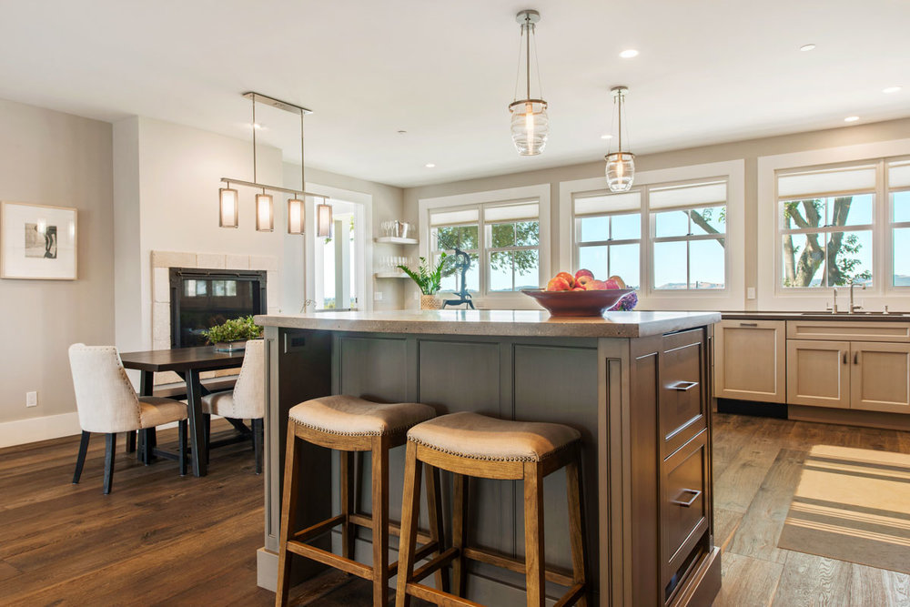 Above and below: A remodeled Napa, CA farmhouse with Ovo blown glass pendants above the kitchen and Uptown Mesh fixtures in the dining area and entry.&nbsp;