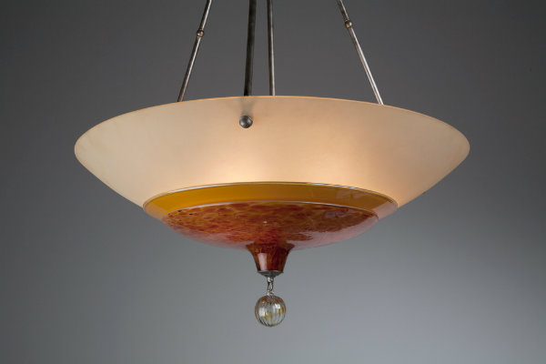  This subtly Asian-inspired fixture elevates a simple bowl form to celebrity status by combining colorful layers of kiln-slumped and artisan-blown glass. A blown glass ball finial adds the finishing touch. 
