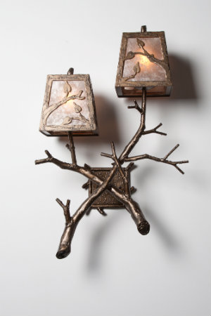  This rustic chic sconce design features crossing branches with natural textures and a polished look, perfect for traditional and transitional designs. 