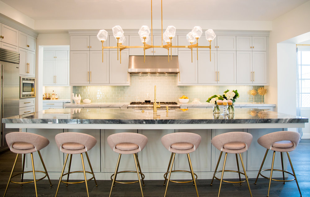 This glamorous modern kitchen features a Gem Belvedere linear suspension in Gilded Brass finish. Designer Jaki Yermian is making a name for herself and her Carlsbad, CA based firm JY Design Interiors &nbsp;with her ethereal designs.&nbsp;&nbsp;