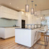 These urban chic Uptown Mesh pendants beautifully illuminate a bright, modern kitchen without weighing the space down.