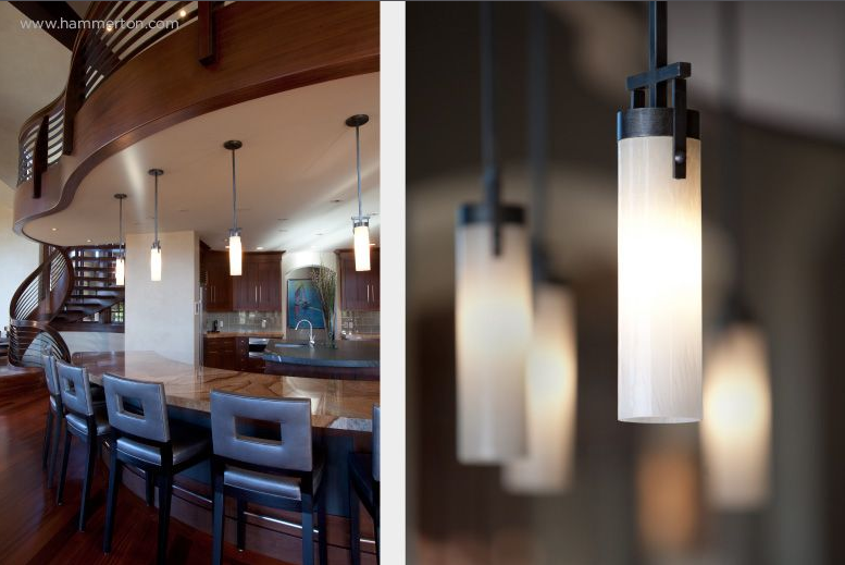  Artful blown glass shades create a beautiful contrast to the matte black finish of these custom kitchen pendants. 