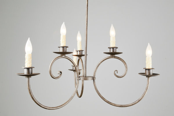  Melted wax candles and elegant metal curves lend an authentic, traditional feel to this modified Seriph chandelier. 