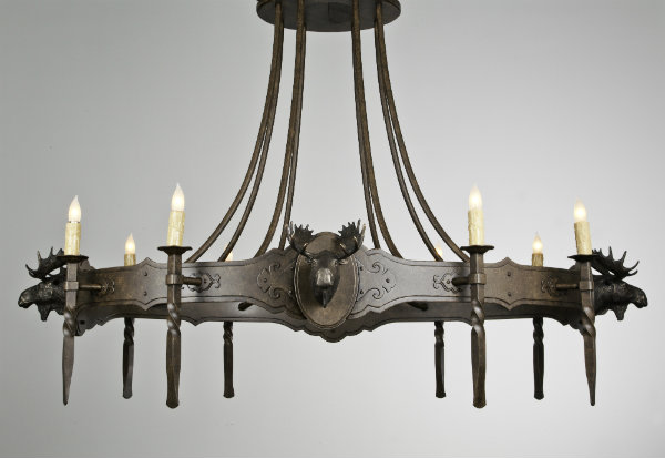  Defined by a sculptural moose motif crafted in bronze, this classic lodge-style candle chandelier features stunning metalwork and artisan detail. 