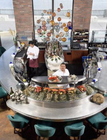  Like bubbles rising from the bottom of the ocean, a multitude of colorful blown glass spheres in this custom Lightspann chandelier sprinkles a popular San Francisco seafood bar with a whimsical aesthetic. 