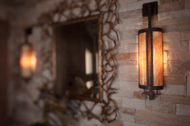 contemporary indoor sconces sport a dark art glass diffuser, fine mesh accents, and a River Rust finish.