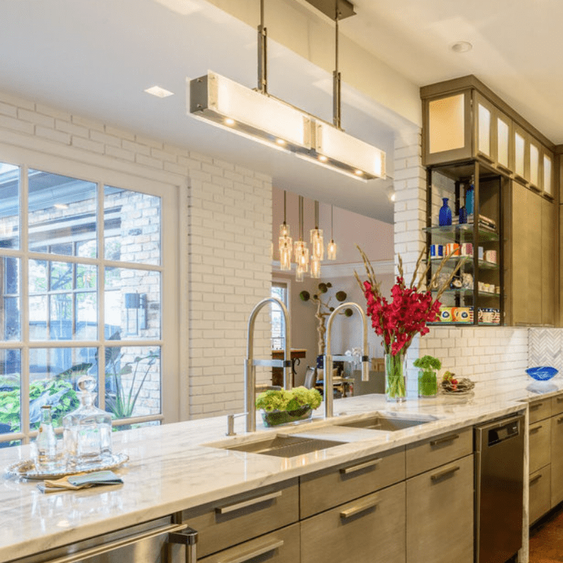 a hanging rectangular chandelier with suspended multi-bulb pendant chandelier in the background